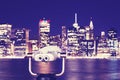 Binoculars pointed at New York City skyline at night. Royalty Free Stock Photo