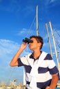 Binoculars teenager boy on boat marina Royalty Free Stock Photo