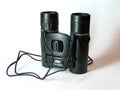 Binoculars. Binoculars on a white background with a shadow. Binoculars made of black metal close-up. Template. Magnifying device f