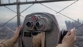 Binoculars, woman at observation deck on a skyscraper looking over New York. Royalty Free Stock Photo