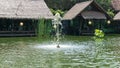 Bintaro, March 2022 - Green water pond with fountain and wooden traditional gazebo outdoor design of Telaga Sampireun Restaurant