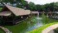 Bintaro, March 2022 - Green water pond with fountain and wooden traditional gazebo outdoor design of Telaga Sampireun Restaurant