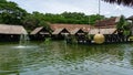 Bintaro, March 2022 - Green water pond with fountain and wooden traditional gazebo outdoor design of Telaga Sampireun Restaurant