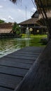 Bintaro, March 2022 - Green water pond with fountain and wooden traditional gazebo outdoor design of Telaga Sampireun Restaurant