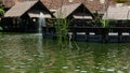 Bintaro, March 2022 - Green water pond with fountain and wooden traditional gazebo outdoor design of Telaga Sampireun Restaurant