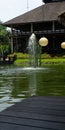 Bintaro, March 2022 - Green water pond with fountain and wooden traditional gazebo outdoor design of Telaga Sampireun Restaurant