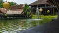 Bintaro, March 2022 - Green water pond with fountain and wooden traditional gazebo outdoor design of Telaga Sampireun Restaurant