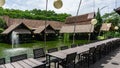 Bintaro, March 2022 - Outdoor natural dining wooden table with round lamp and water fountain of Telaga Sampireun Restaurant