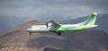 Binter Canarias Airlines flies in the blue sky with clouds. Landing at Tenerife Airport. Mountains in the background