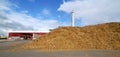 Bio power plant and storage of wooden fuel against blue sky Royalty Free Stock Photo