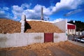 bio power plant storage of wooden fuel against blue sky Royalty Free Stock Photo