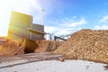 Bio power plant with storage of wooden fuel against blue sky Royalty Free Stock Photo