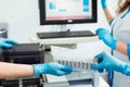 Biochemical analysis of blood. Hands of laboratory assistant loading sample tubes before loading to biochemical analyzer Royalty Free Stock Photo