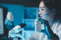 biochemical research scientist working with microscope for coronavirus vaccine development in, Portrait of a Beautiful Female Royalty Free Stock Photo