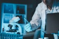 biochemical research scientist working with microscope for coronavirus vaccine development in, Portrait of a Beautiful Female Royalty Free Stock Photo