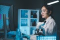 biochemical research scientist working with microscope for coronavirus vaccine development in, Portrait of a Beautiful Female Royalty Free Stock Photo