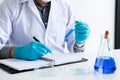 Biochemistry laboratory research, Chemist is analyzing sample in Royalty Free Stock Photo