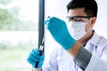 Biochemistry laboratory research, Scientist or medical in lab coat holding test tube with reagent with drop of color liquid over Royalty Free Stock Photo