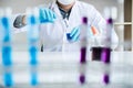 Biochemistry laboratory research, Scientist or medical in lab coat holding test tube with reagent with drop of color liquid over Royalty Free Stock Photo