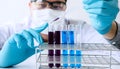 Biochemistry laboratory research, Scientist or medical in lab coat holding test tube with reagent with drop of color liquid over Royalty Free Stock Photo