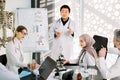 Biochemistry, pharmacology, drug industry, clinical trials. Young Asian doctor talks about the results of clinical trial