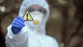 Biochemistry scientist showing generic caution sign in hand, warning disaster Royalty Free Stock Photo
