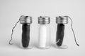 Biodegradable dental flosses in glass jars on light background Royalty Free Stock Photo