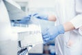 Bioengineer installs blood plasma sample in automatic tester for DNA analysis and checks response to antibiotics Royalty Free Stock Photo