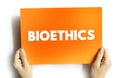 BIOETHICS text on card held by hands, concept of ethics, biology, medicine, research, and human values in science Royalty Free Stock Photo