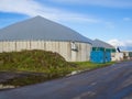 Biogas energy plant on farm in countryside with blue sky, Schleswig-Holstein, Germany Royalty Free Stock Photo