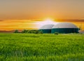 Biogas plant at sunset with corn field Royalty Free Stock Photo