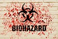 Biohazard sign on the wall with red toxic sprays on the wall.