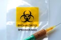 Biohazard specimen bag with a syringe and brown liquid