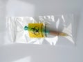 Biohazard specimen bag with a syringe and brown liquid