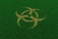 Biohazard symbol from thatch on green grass