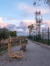 Biohealthy circuit for the elderly with two exercise equipment in a park with a wooden fence walkway