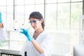 Biologist asian woman working with medical chemicals sample at laboratary Royalty Free Stock Photo