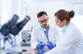 Biologist examining samples in petri dishes in laboratory Royalty Free Stock Photo