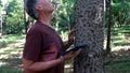 Biologist inspecting the thorns on the the Anigic Tree