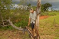 Biologist out in the savannas of Brazil, inspecting a tree
