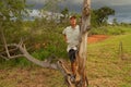 Biologist out in the savannas of Brazil, inspecting a tree