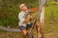 Biologist out in the savannas of Brazil, inspecting a tree