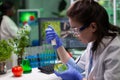 Biologist scientist doctor dropping liquid in petri dish with fungi colony