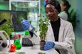 Biologist scientist putting solution from medical flask