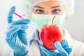 A biologist woman genetically modifies an apple for longer life. Female researcher or scientist using laboratory equipment for