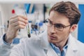 Biologist working with plant in flask Royalty Free Stock Photo