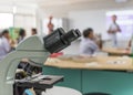 Biology or chemistry science class study with microscope and blur background of school student group learning in blurry lab Royalty Free Stock Photo