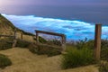 Long exposure of Beautiful Blue Bioluminescence at Black`s Beach in San Diego. Trail and wooden stairs in the foreground.