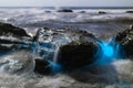 Bioluminescent tide glows on some rocks in La Jolla, California