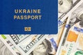 Biometrical Ukrainian passport over money background. Ukraine citizen travel documents lying on US one hundred dollar banknotes. V Royalty Free Stock Photo